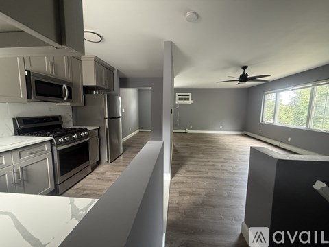 A modern kitchen with a large island and stainless steel appliances.