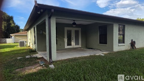A house with a porch and a ceiling fan is for sale.
