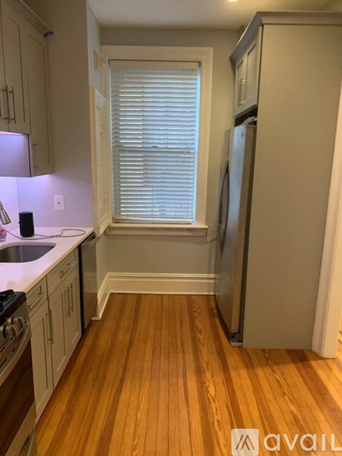 A kitchen with wooden floors and white appliances.