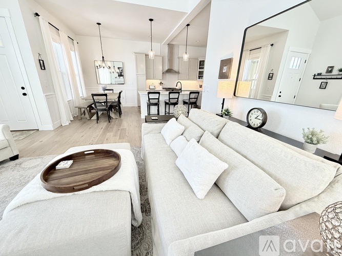 A modern living room with a white sofa and a wooden coffee table.