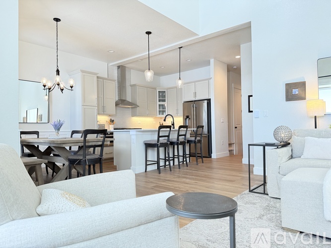 A modern kitchen with a dining table and chairs.