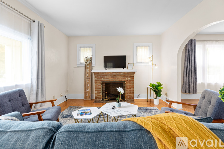 A living room with a fireplace and a television.