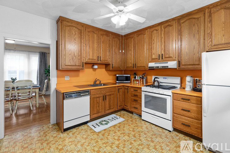 A kitchen with wooden cabinets and a white refrigerator.
