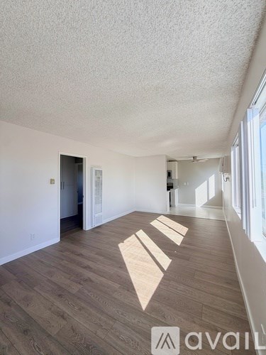 A room with wooden flooring and a white ceiling.