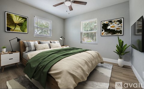 A bedroom with a bed, a ceiling fan, and two windows.