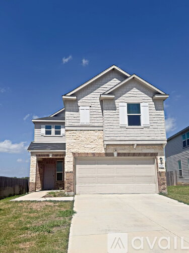 A two-story house with a garage is for sale.