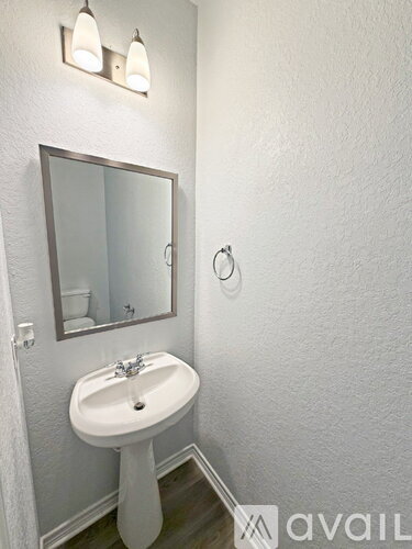 A bathroom with a sink and mirror.
