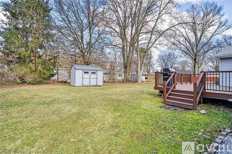 A backyard with a shed and a deck.