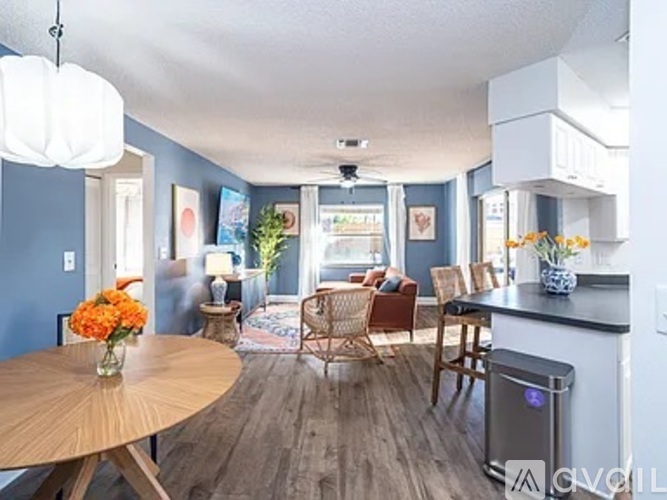 A kitchen with a table and chairs in the middle of the room.