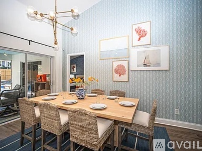 A dining room with a wooden table and chairs.