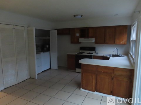 A kitchen with white cabinets and a white counter top.