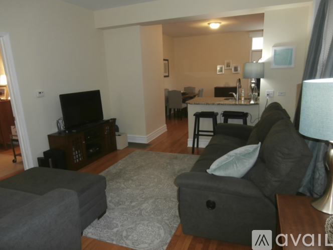 A living room with a grey couch and a television.