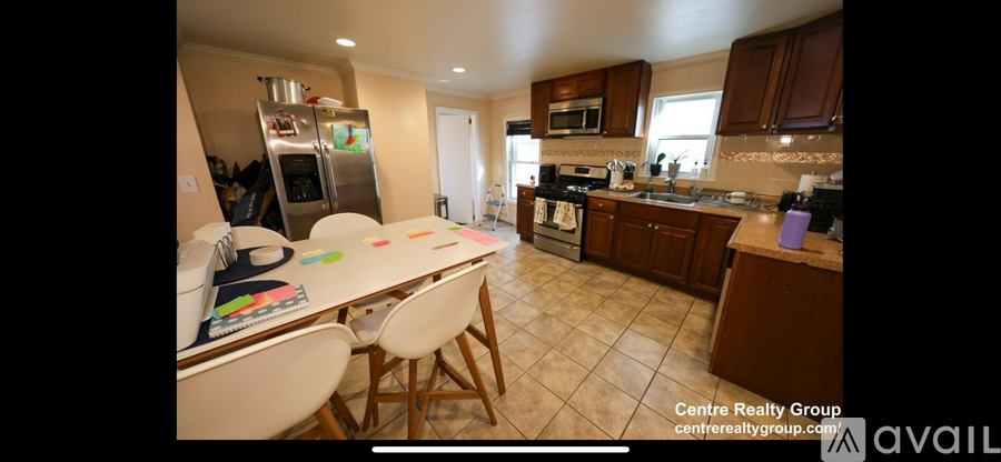 A kitchen with a table and chairs in the middle of the room.