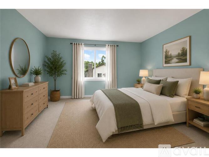 A bedroom with a large bed, a dresser, and a window with curtains.