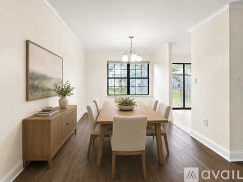 A dining room with a wooden table and chairs.