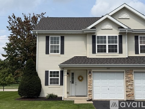 A house with a garage door that says "AVAIL" on it.