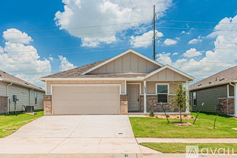 A house with a garage and a driveway in front of it.