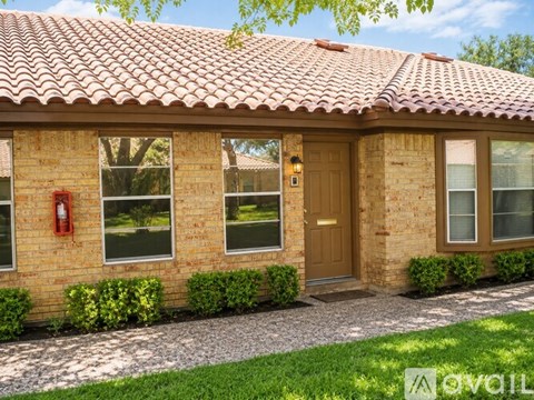 A house with a red fire hydrant on the left side of the front door.