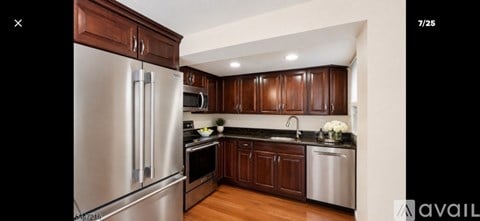 A modern kitchen with wooden cabinets and stainless steel appliances.