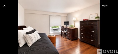 A bedroom with a large bed and a wooden dresser.