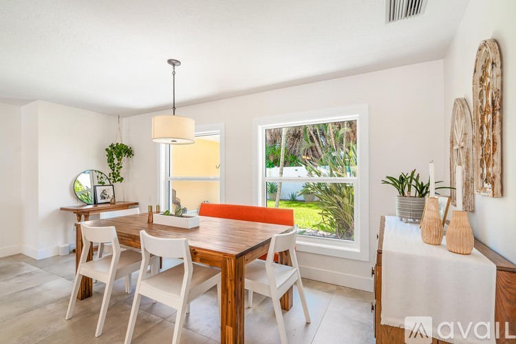 A dining room with a wooden table and chairs.