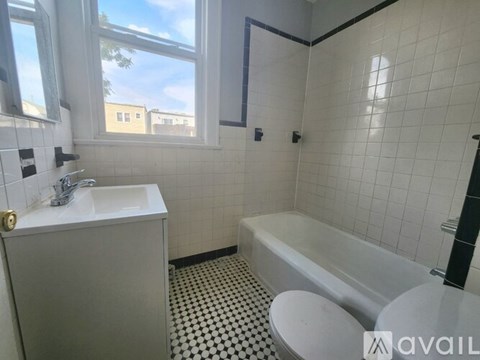 A bathroom with a white sink, toilet, and bathtub.