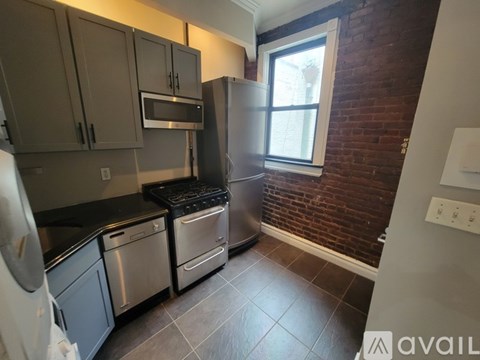 A kitchen with a stove top oven and a refrigerator.