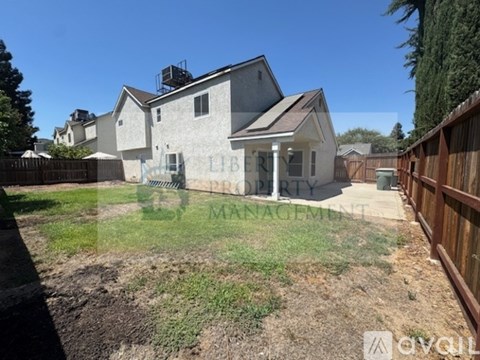 A house with a yard is for sale.