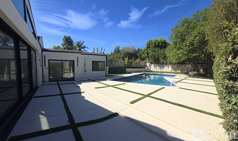 A modern house with a pool in the backyard.