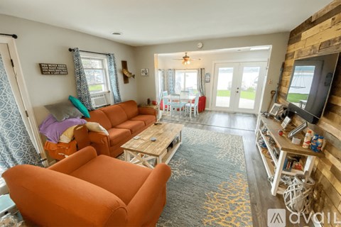 A living room with a sofa set and a television.