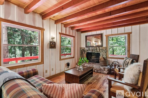 A cozy living room with a fireplace and a couch.