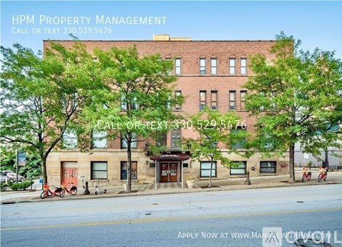 A building with the text "HPM PROPERTY MANAGEMENT" on a sign in front of it.