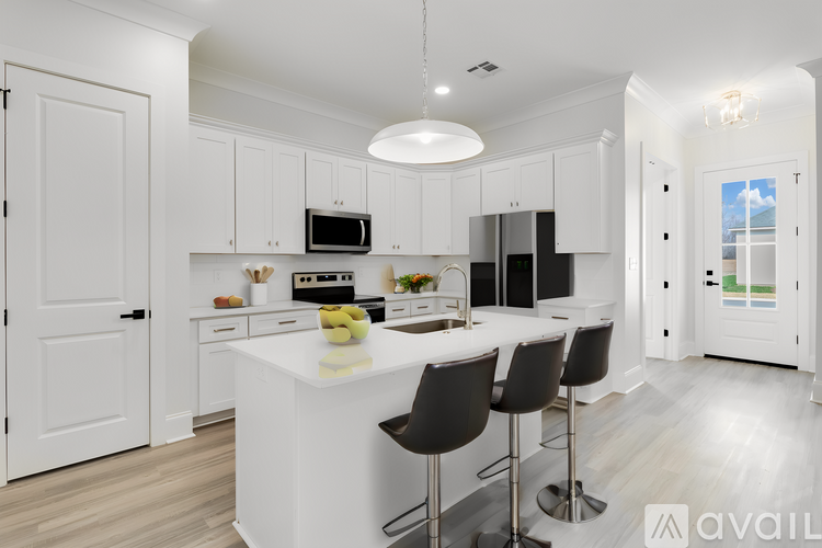 A modern kitchen with white cabinets and a central island.