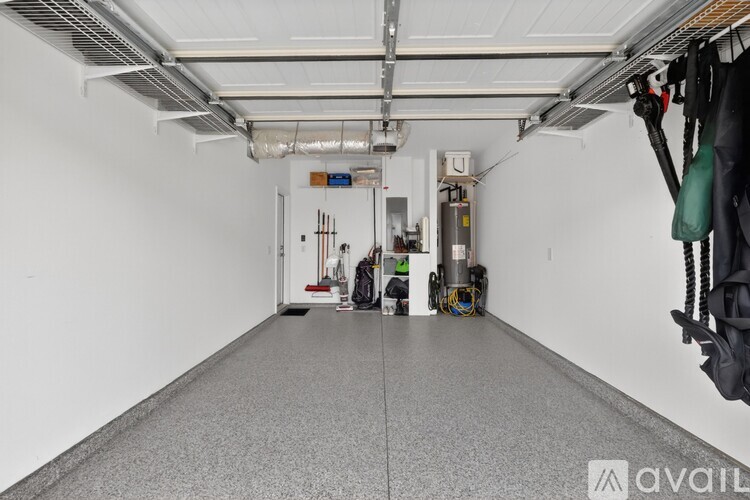 A spacious garage with a concrete floor and white walls.