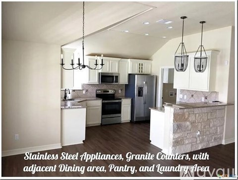 A kitchen with stainless steel appliances and granite counters.