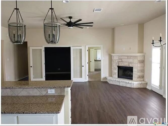 A living room with a fireplace and a television.