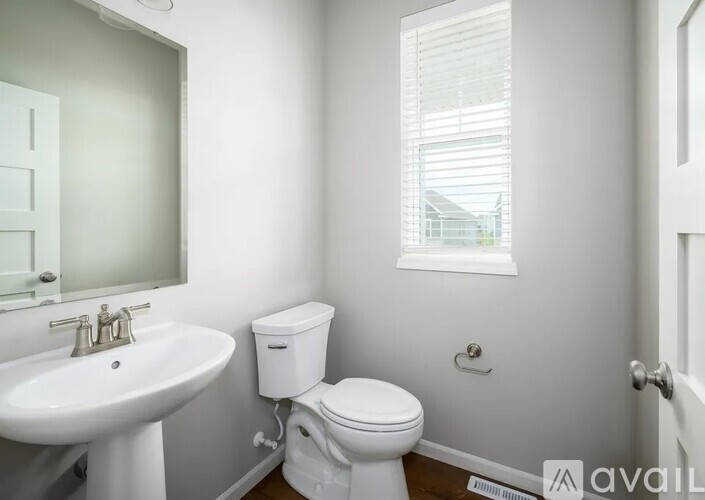 A white toilet sits next to a sink in a small bathroom.