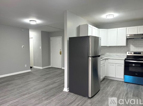 A kitchen with a stainless steel refrigerator and a dishwasher.