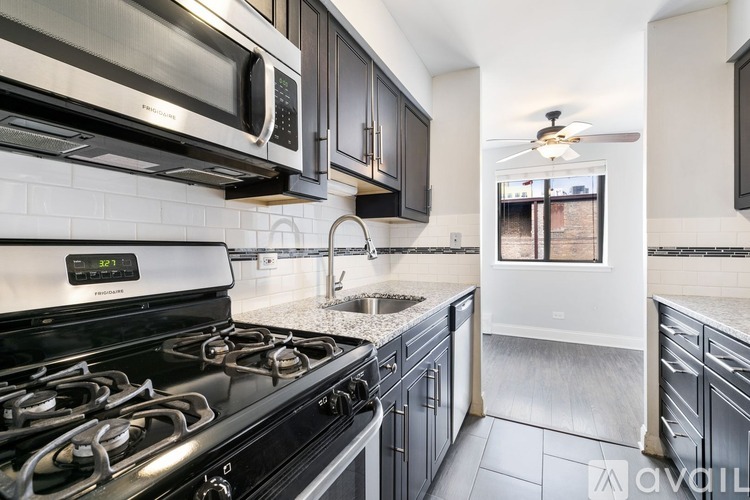 A modern kitchen with a stove, microwave, and oven.