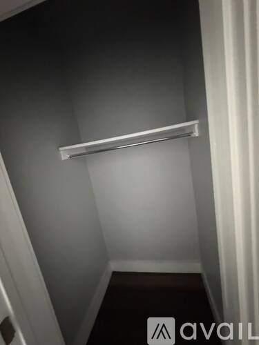 A white shelf is mounted on a wall.