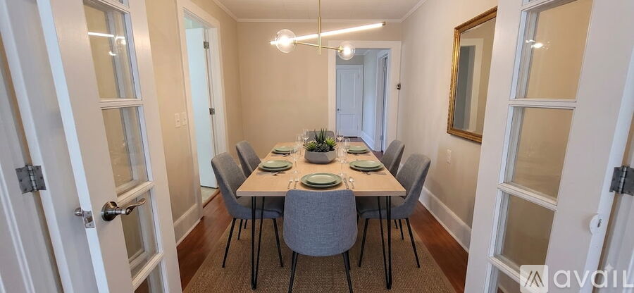 A dining room with a table set for six.