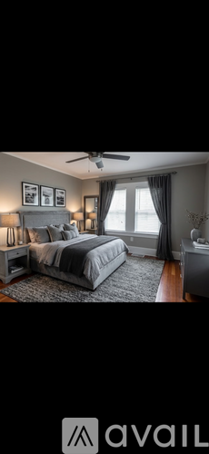 A bedroom with a large bed and a ceiling fan.