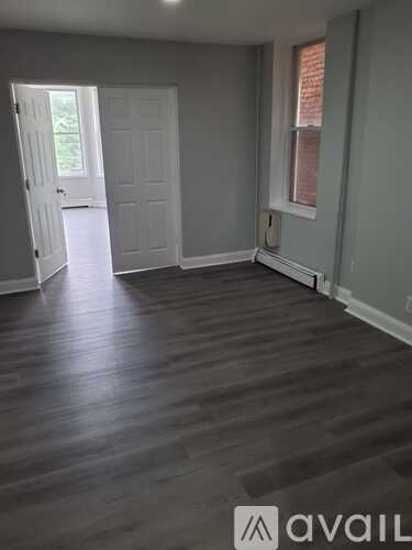 A room with wooden floors and a white door.