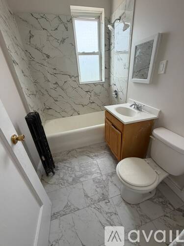 A bathroom with a toilet, sink, and bathtub.