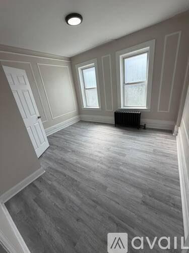 A room with grey flooring and white walls.
