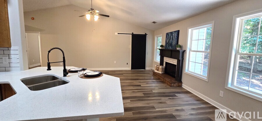 A kitchen with a sink and a fireplace.