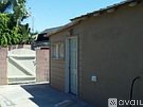 A small house with a white door and a brown wall.