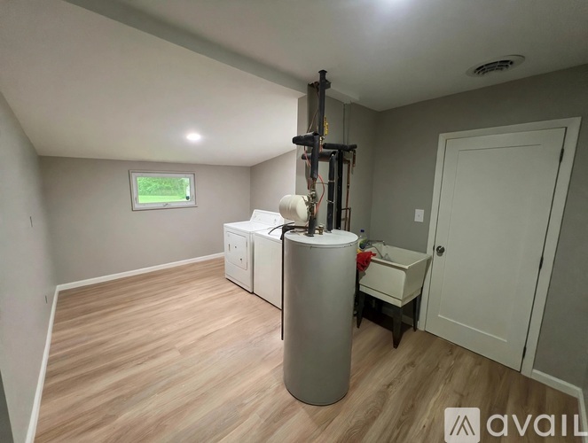 A room with a tank, a cabinet, and a window.