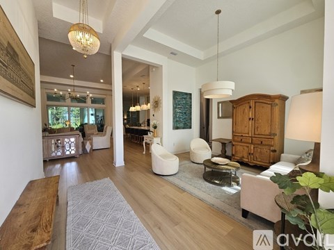 A well-lit, spacious living room with a variety of furniture and decor.