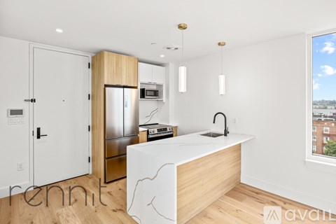 A kitchen with a white counter and a sink.
